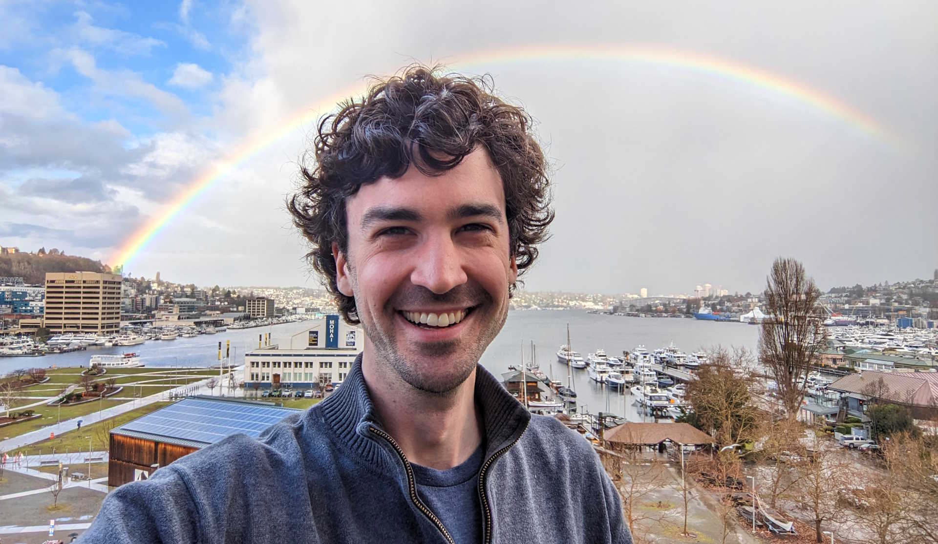 I'm standing in front of a rainbow, with Lake Union, Seattle in the background