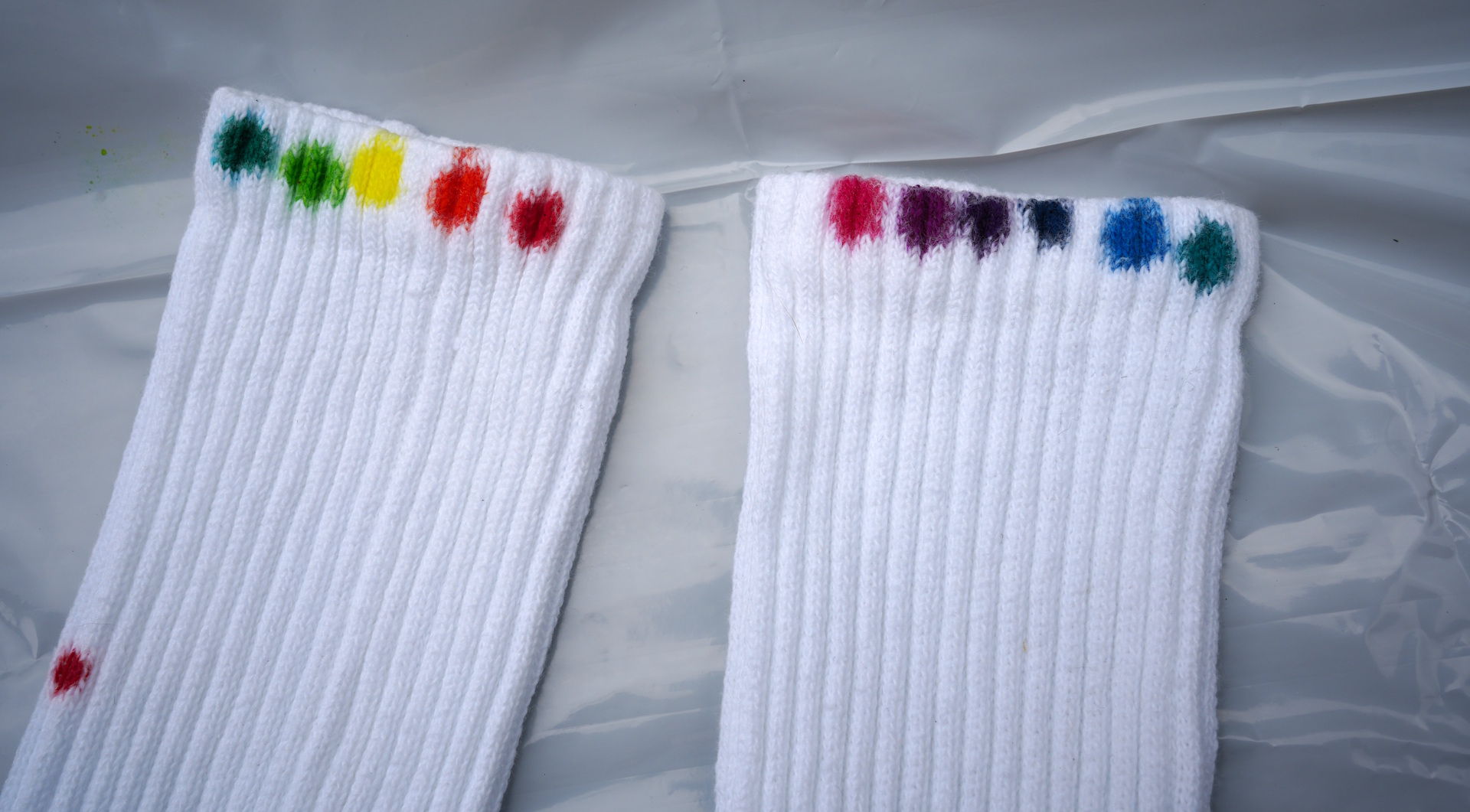 white socks with 11 rainbow-coloured spots